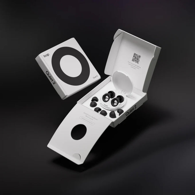 Loop Quiet 2 earplugs in the packaging showing the white Carry Case and extra sizes of eartips on a black background